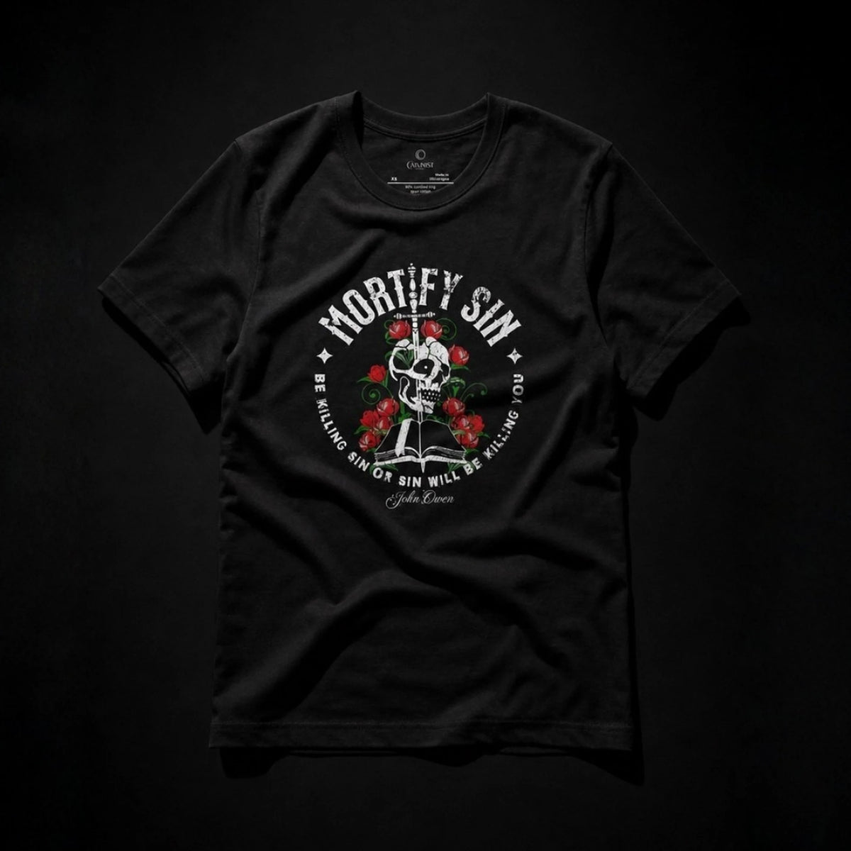 Mortify Sin black unisex T-shirt front flat lay with John Owen quote and skull floral artwork