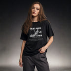 Dead Men Don't Grab tee worn by female model on dark studio background