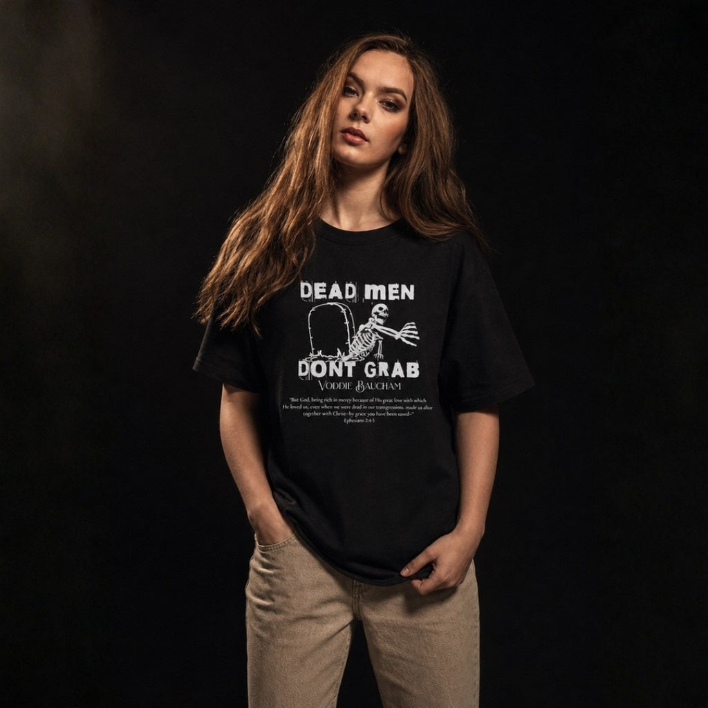 Dead Men Don't Grab unisex tee worn by female model against gray studio background