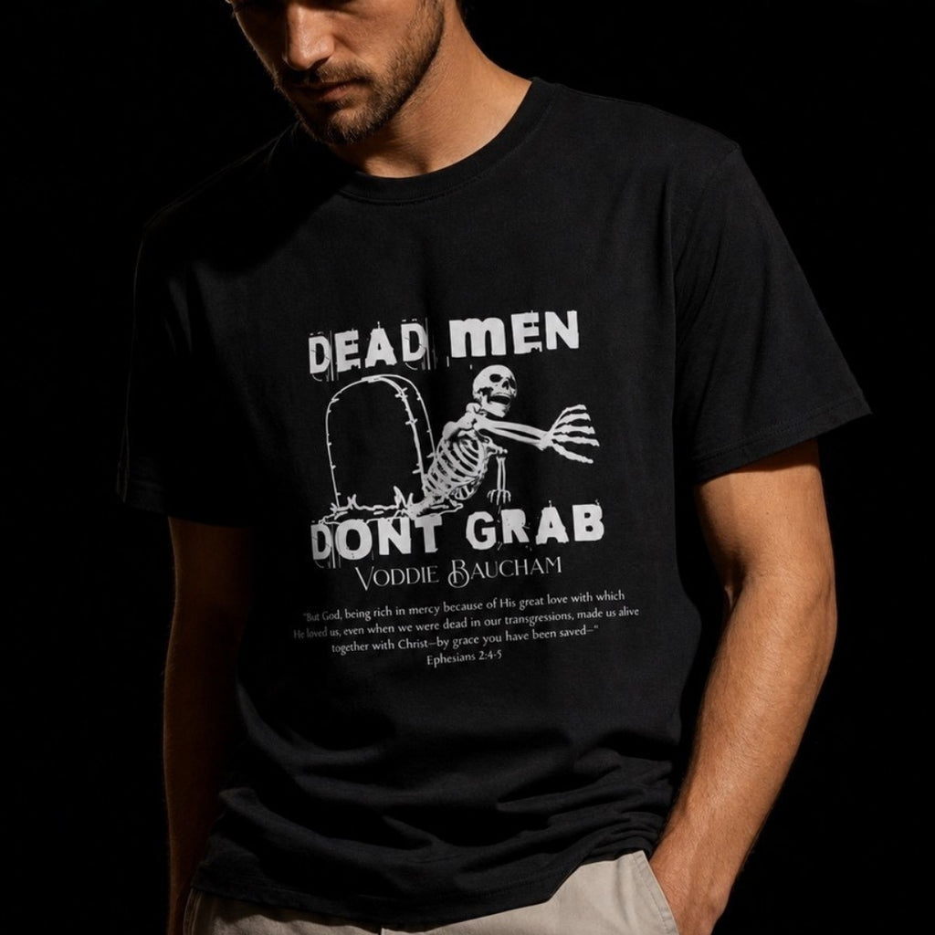 Close-up of Dead Men Don't Grab white skeleton and Voddie Baucham quote print on black tee
