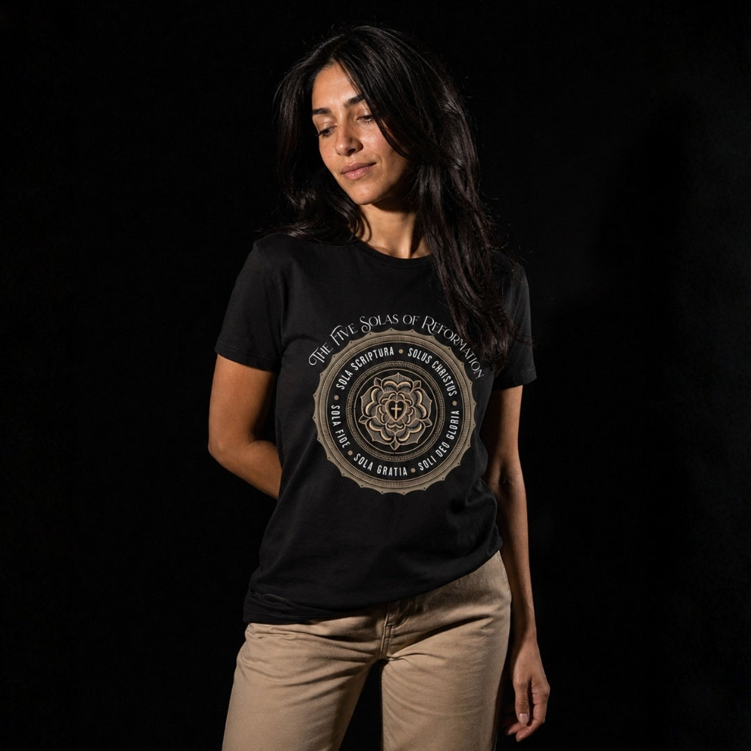 Woman wearing a black Five Solas T-shirt with tan trousers, showing the front design and relaxed fit.