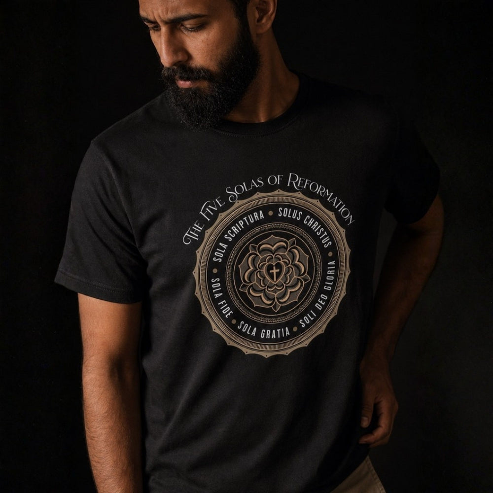 Close-up of a man wearing the black Five Solas unisex tee, highlighting the gold circular chest print.