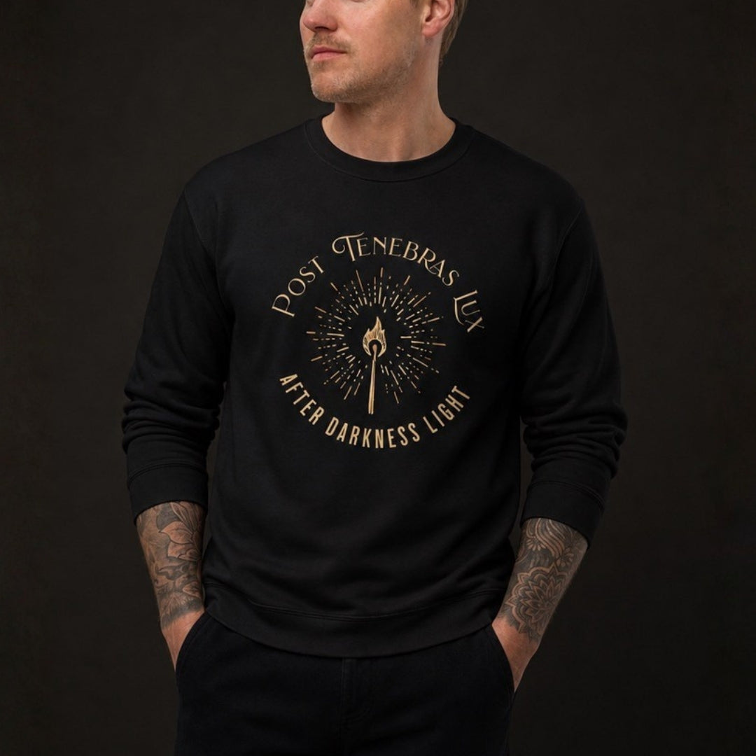 Male model wearing black Post Tenebras Lux crewneck sweatshirt, gold torch print close view