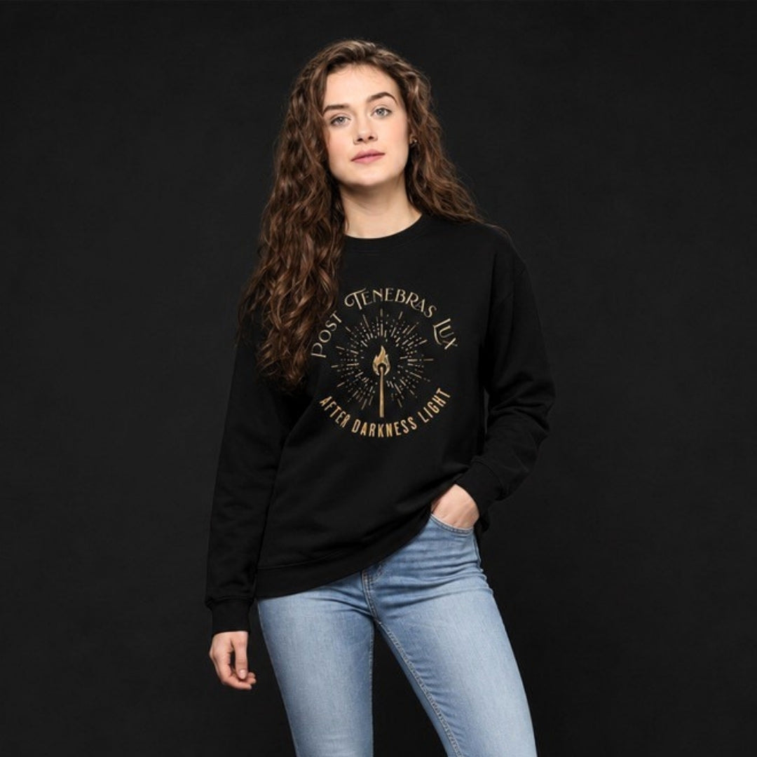 Female model wearing black Post Tenebras Lux crewneck sweatshirt on dark background