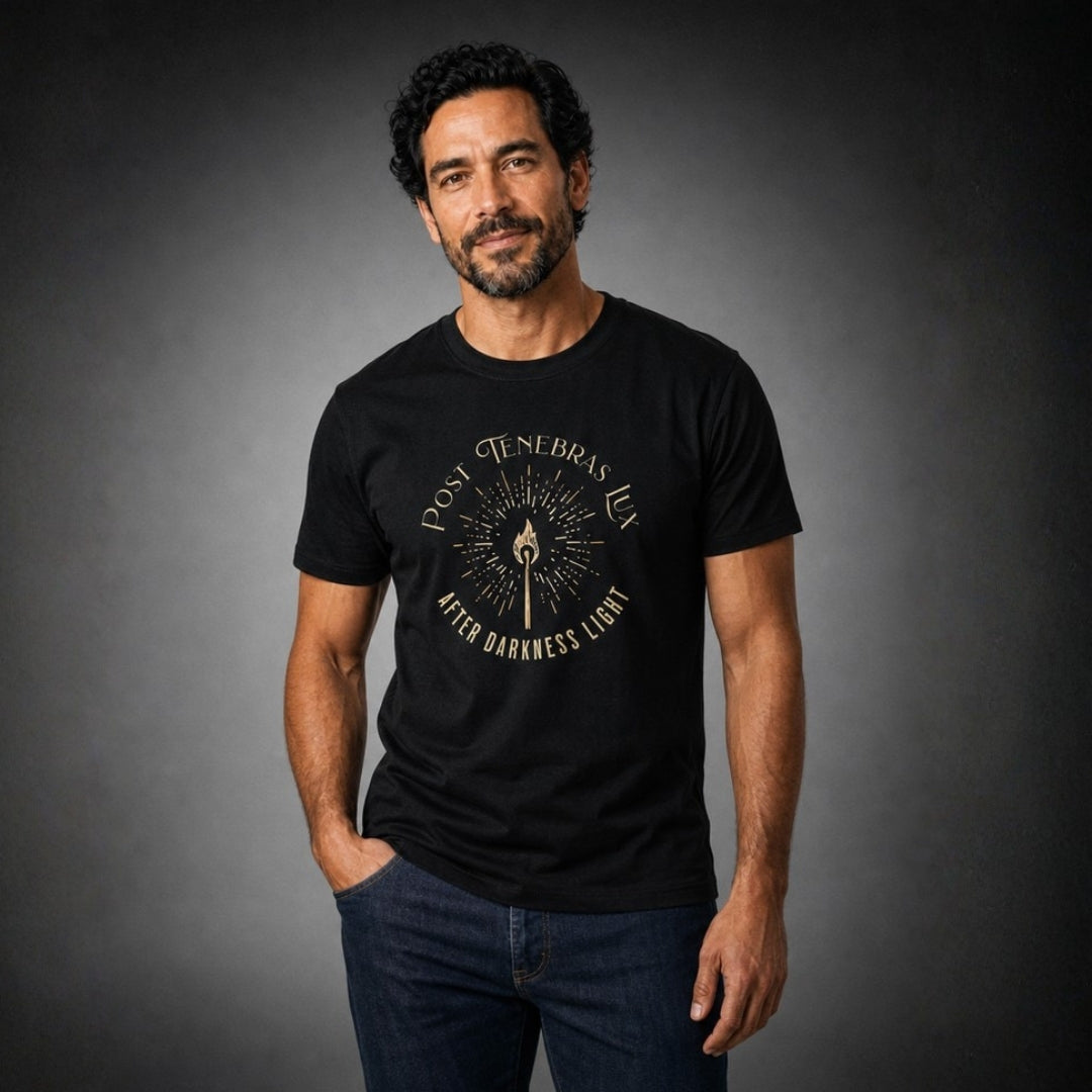 Man wearing a black Post Tenebras Lux T-shirt with dark jeans against a charcoal studio background.