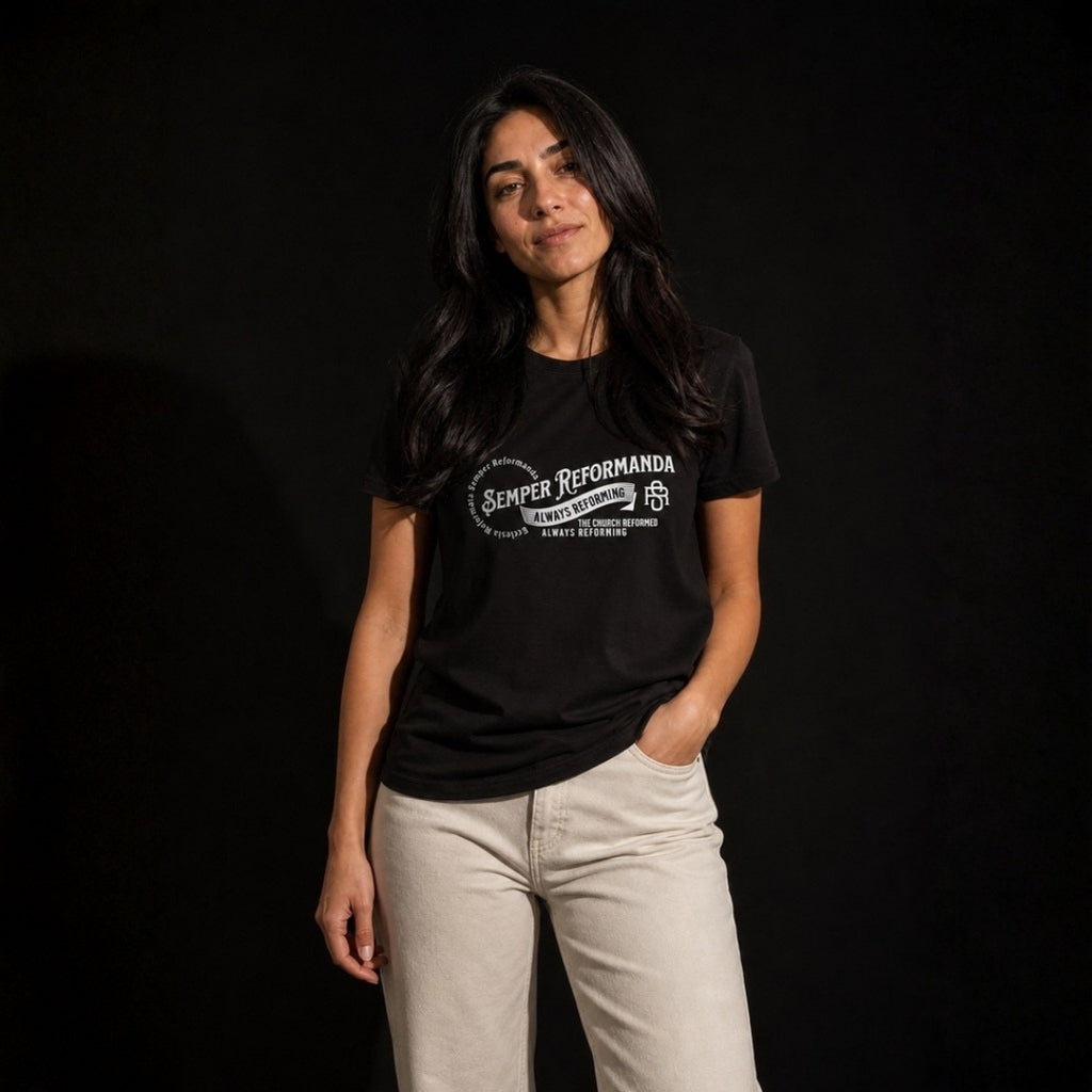 Woman modeling black Semper Reformanda tee against dark studio background