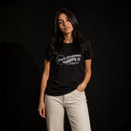 Woman modeling black Semper Reformanda tee against dark studio background