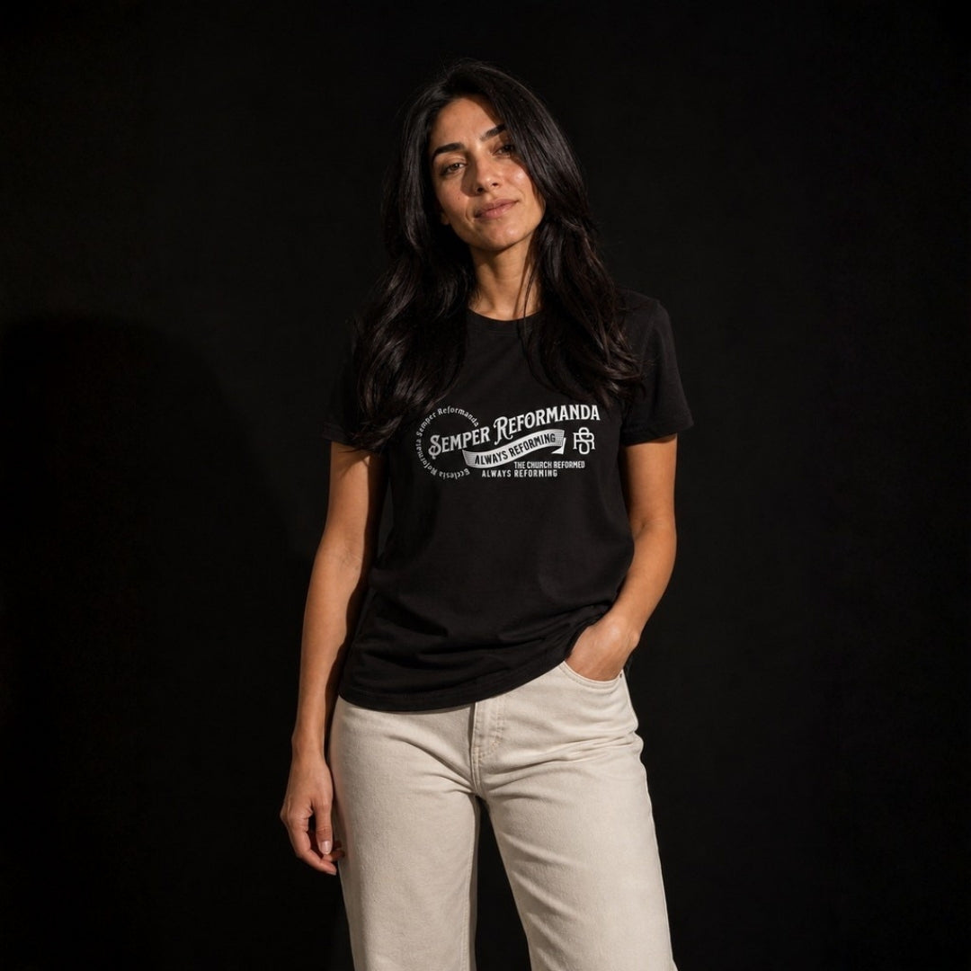 Woman modeling black Semper Reformanda tee against dark studio background