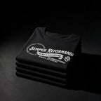 Folded black Semper Reformanda tees with white Always Reforming design