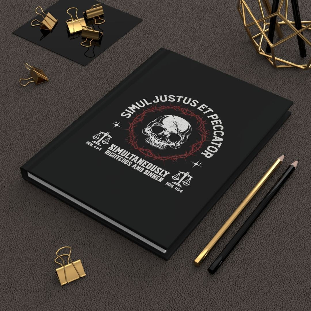 Black Simul Justus et Peccator hardcover journal on a desk